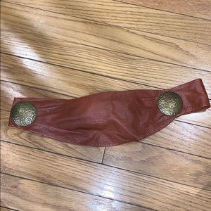 Brown leather belt with bronze accents